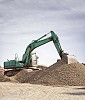 Excavator working on a rubble hill