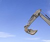 Excavator bucket on a blue sky background