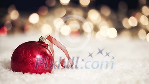 Red christmas ball on the snow