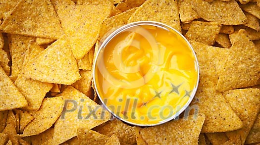Background of nachos with cheese sauce Background of nachos with cheese sauce
