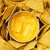 Background of cheese sauce with nachos