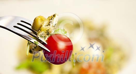 Fork with pasta and tomato