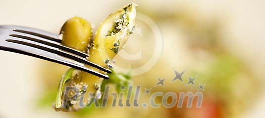 Fork with pasta and an olive Fork with pasta and an olive
