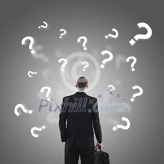 Businessman with question marks surrounding him
