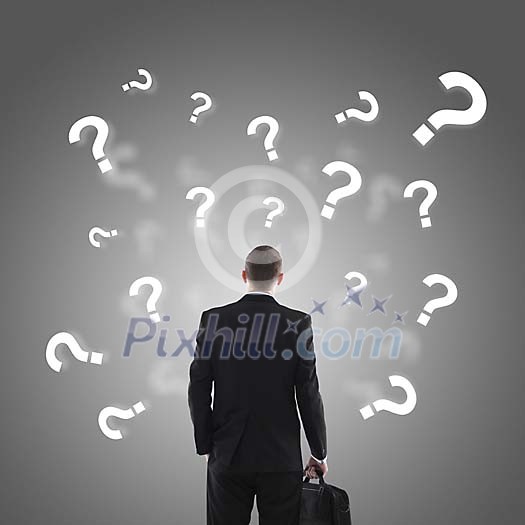 Businessman with question marks surrounding him Businessman with question marks surrounding him