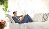 Man reading a book on the sofa