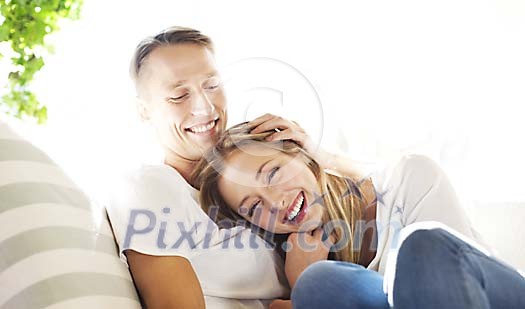 Young couple cuddling and smiling