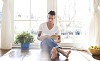 Man sitting on the floor reading a book