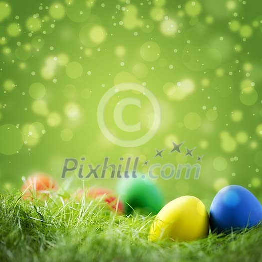 Colorful easter eggs on grass against festive green background with copyspace