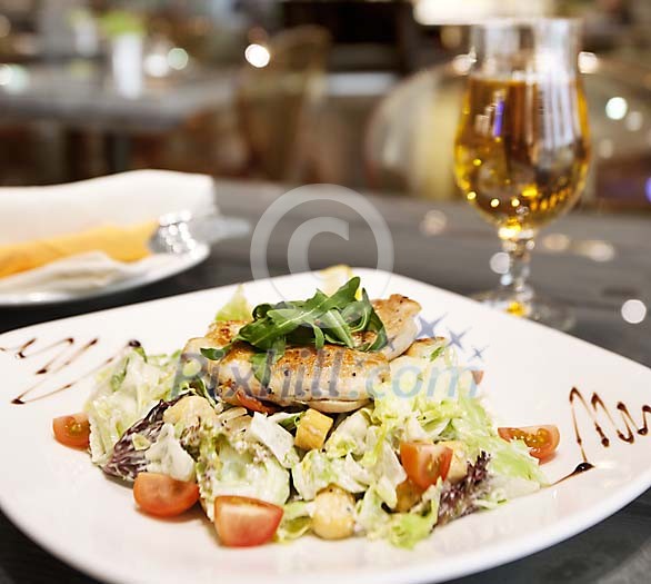 Restaurant serving of chicken and salad