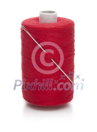 Isolated red sewing thread with a needle
