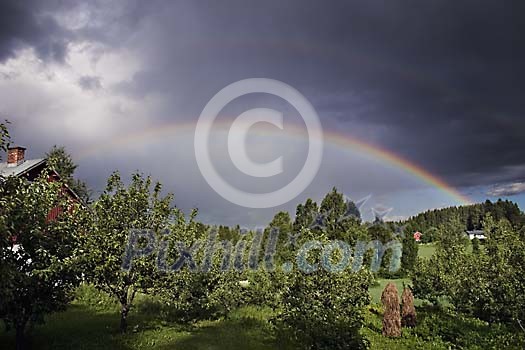 Dramatic sky and sunshine landscape result in beautiful rainbow