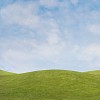 Digital Composite of Green Field and Spring Sky
