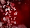 Digitally generated red abstract background, including bokeh elements.