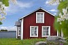 Old red wooden cottage by the sea