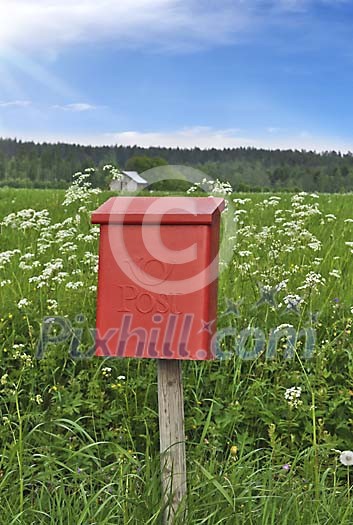 Red mailbox on countryside
