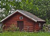 Red log cabin on green yard