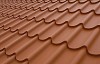 Close-up of a brick red coloured tin roof