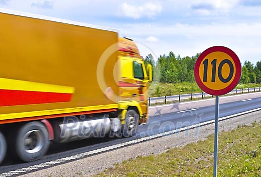 Truck passing a speed limit sign on a Swedish highway Truck passing a speed limit sign on a Swedish highway