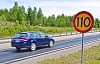 Motion blur car passing a speed limit sign on a Swedish highway