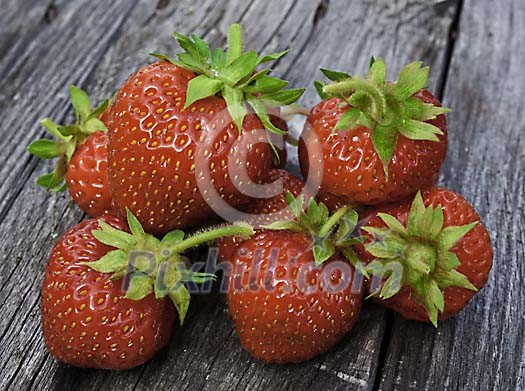 Strawberries on grey wood