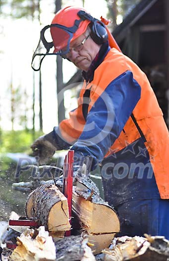 Man splitting firewood with machine
