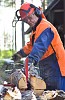 Man splitting firewood with machine