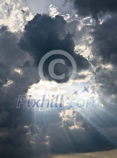 Sun beams shining through dark clouds Sun beams shining through dark clouds