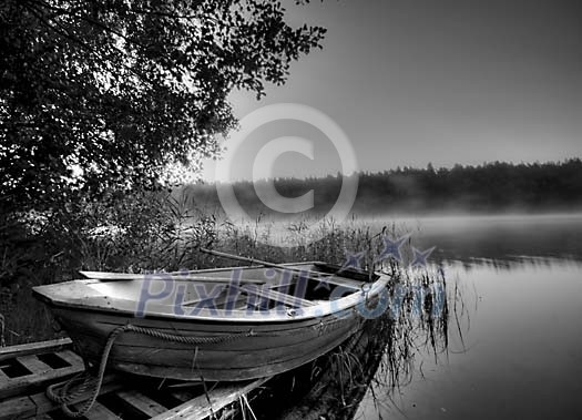 Black and white image of a boat at the lake