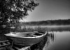 Black and white image of a boat at the lake