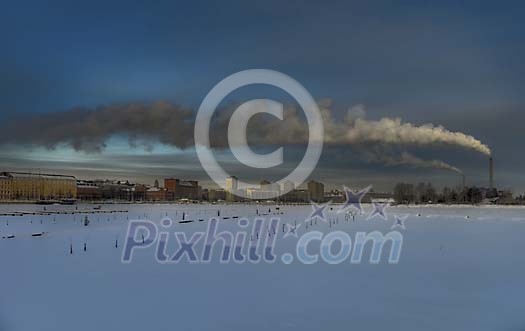 Smoking factory chimney in winter