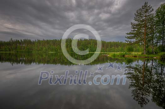 Dark clouds above the lake and forest