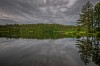 Dark clouds above the lake and forest