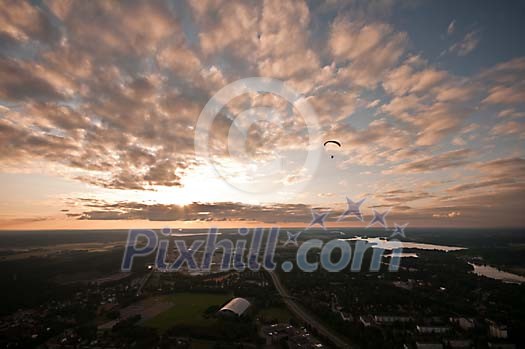 Parachuter above the town in the evening Parachuter above the town in the evening