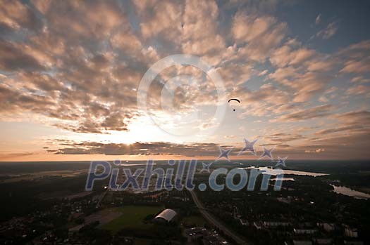 Parachuter above the town in the evening