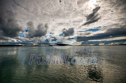 Clouds reflecting on a calm water Clouds reflecting on a calm water