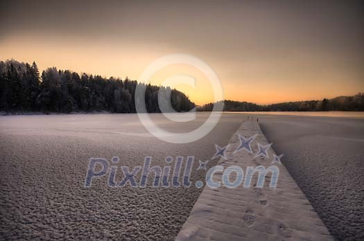 Snowy trail on a frozen lake