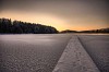 Snowy trail on a frozen lake