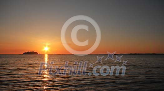 Sun setting at the sea