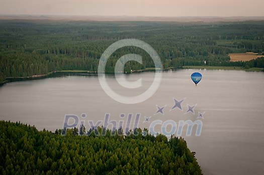 Hot air balloon flying low on the water