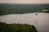 Hot air balloon flying low on the water