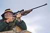 Hunter aiming a rifle