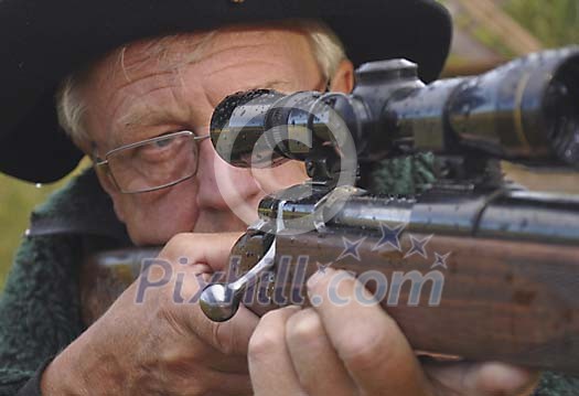 Close-up of a hunter aiming with a rifle Close-up of a hunter aiming with a rifle
