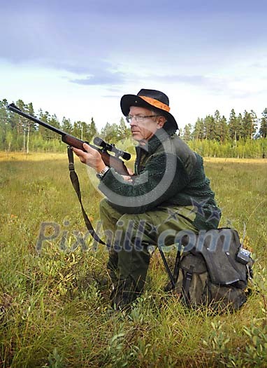 Hunter sitting on a backbag, waiting