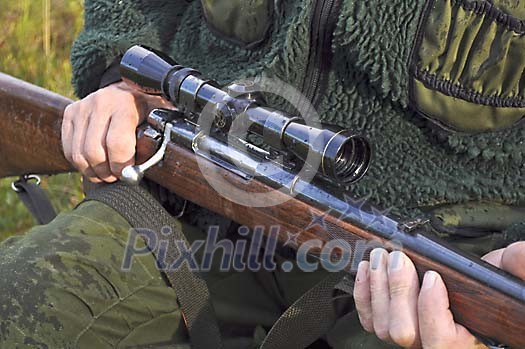 Hunter holding a rifle Hunter holding a rifle