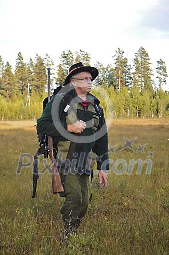 Hunter with a rifle walikng