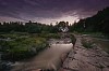 River flowing by the house ruins