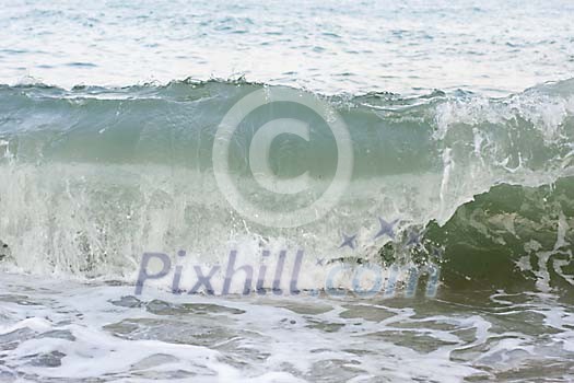 Big wave reaching the beach