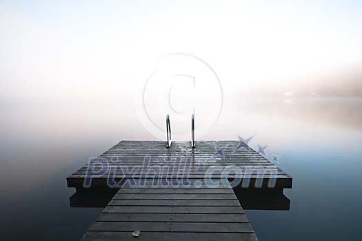Pier on the misty lake