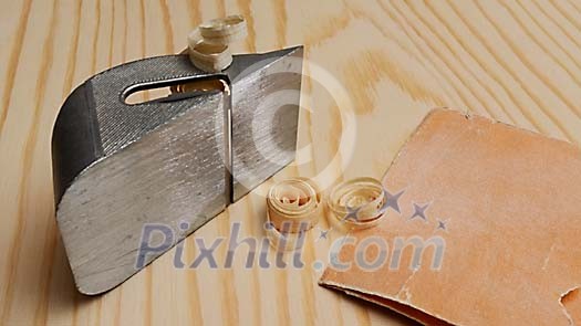 Hand plane on a wooden background